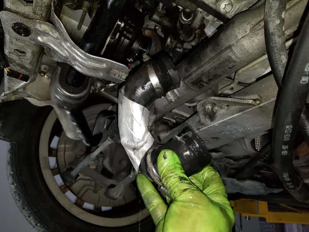 Remove the thermostat coolant hose from the pump.
