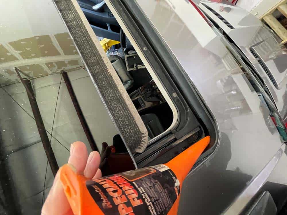 Insert a funnel into the sunroof drain