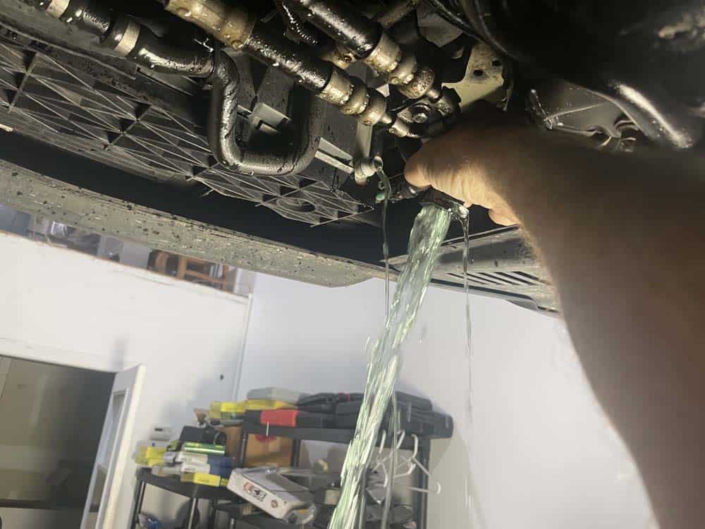 Thoroughly drain the coolant from oil cooler hose