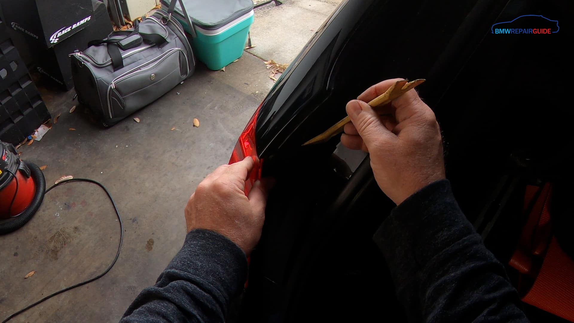 Remove the trim panel from the mounting nuts using a trim removal tool
