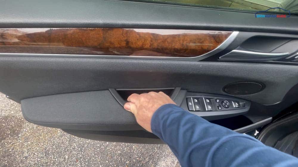 Push the new door pull into the armrest until it snaps into place