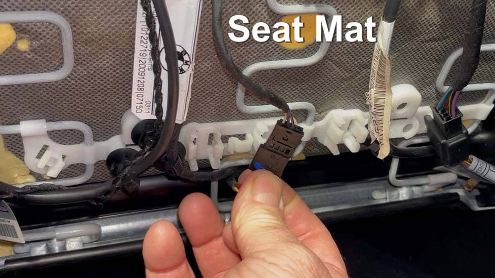 Locate the seat mat occupancy sensor connection