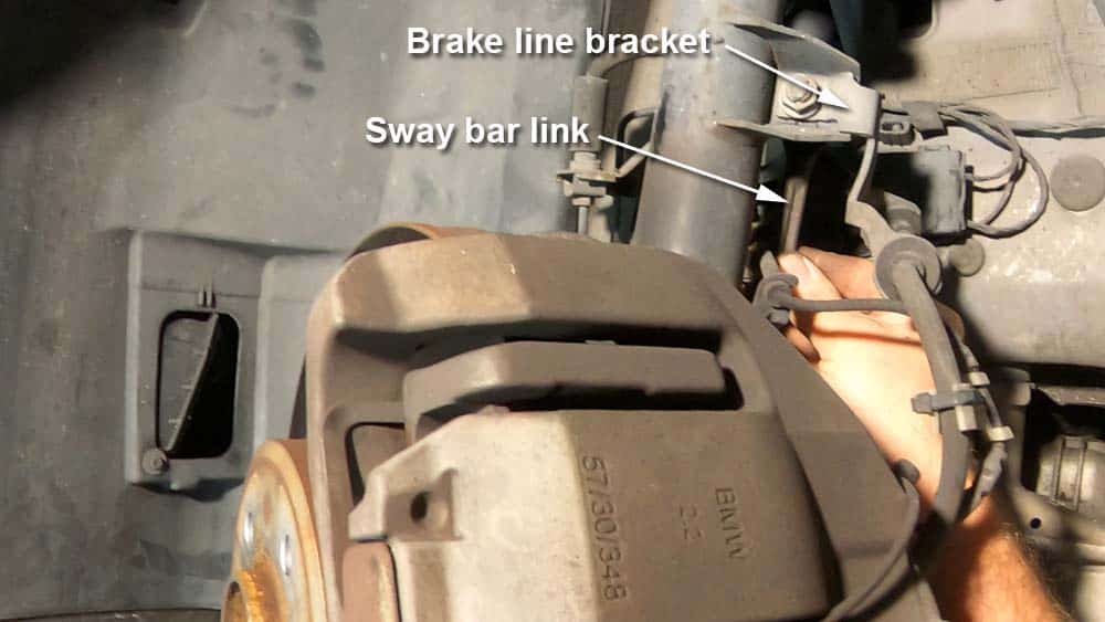 bmw e90 front strut replacement - Locate the sway bar link and brake line bracket