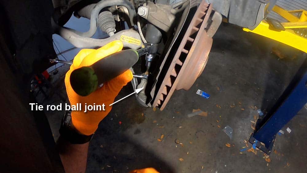 Remove the tie rod ball joint mounting nut
