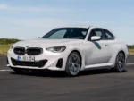 2022-BMW-220i-Coupé-European-model-White-Front-Quarter-View