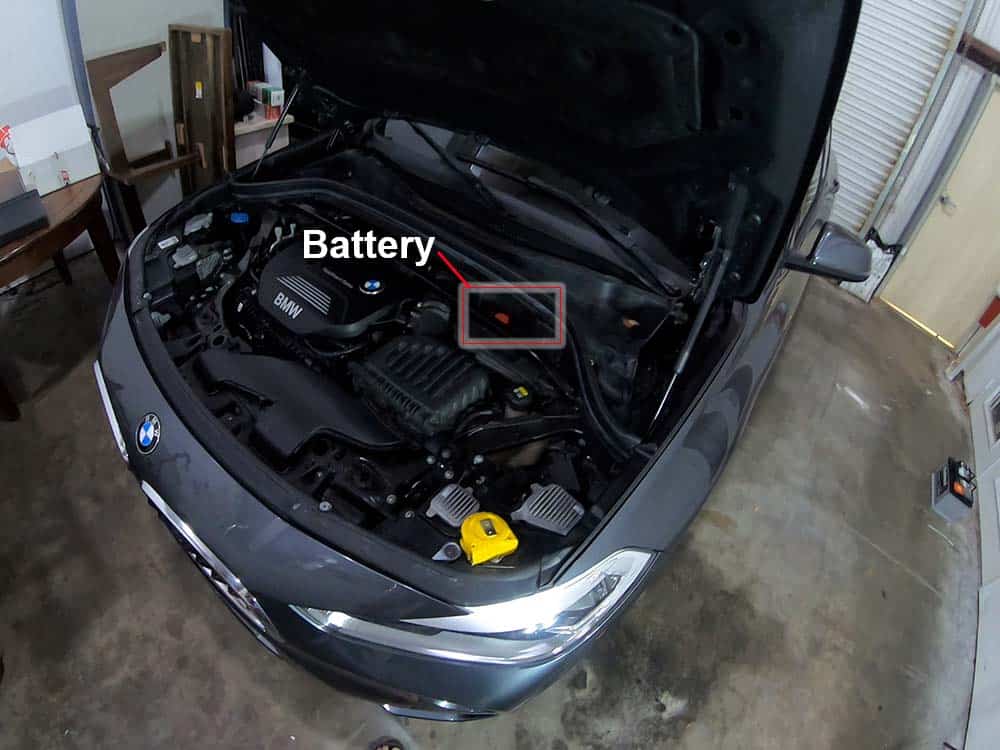 bmw x2 battery replacement - Locate the positive battery terminal in the rear of engine compartment