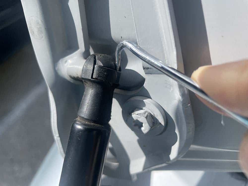 Use a metal pick or flat-tip screwdriver to release the metal locking clip