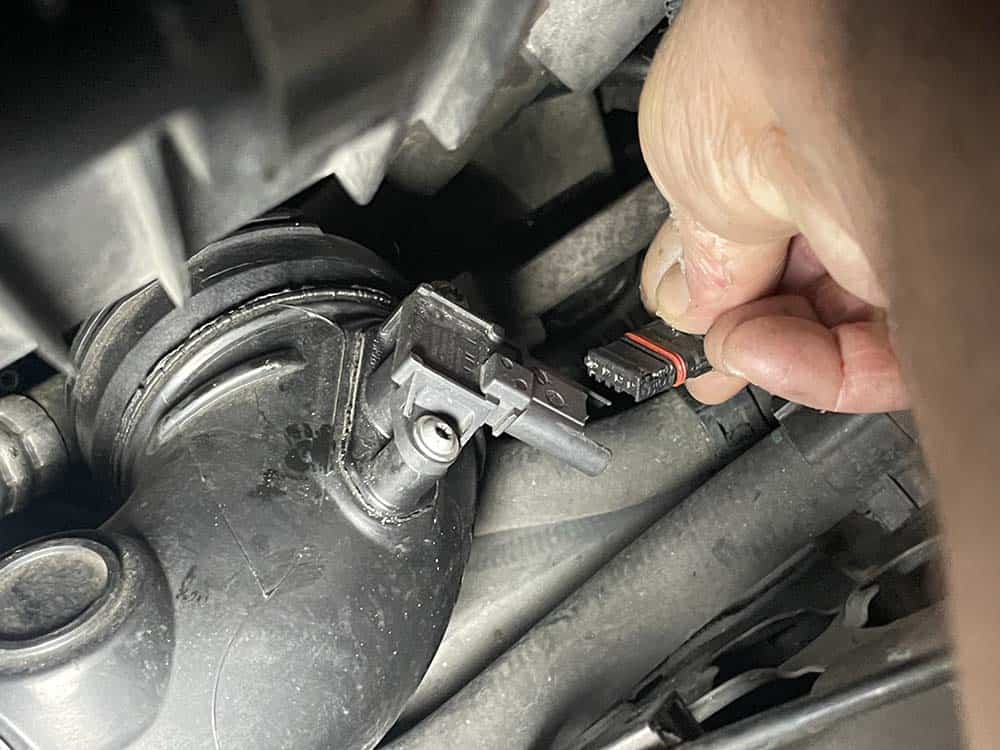 Unplug the pressure sensor and remove the charge pipe from the vehicle
