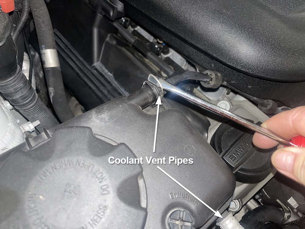 bmw e9x intake plenum removal - unplug the vent lines from the coolant tank