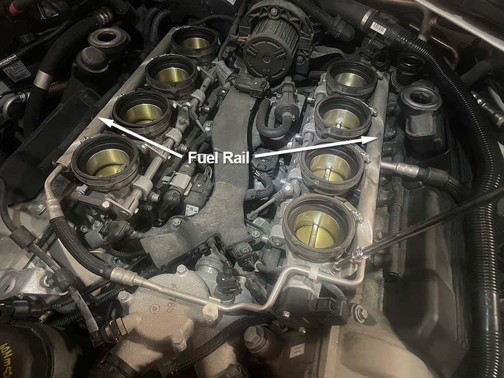 bmw e9x m3 fuel injector replacement - remove the four bolts that mount the fuel rail to the engine heads