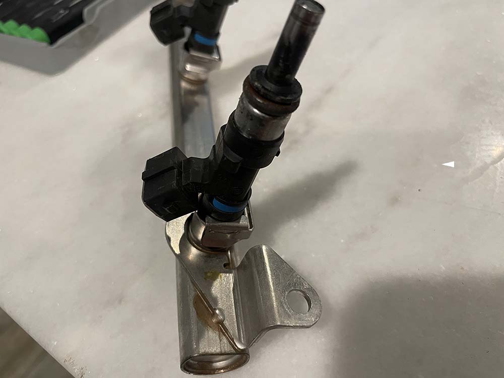 bmw e9x m3 fuel injector replacement - lay the fuel rail on a work bench